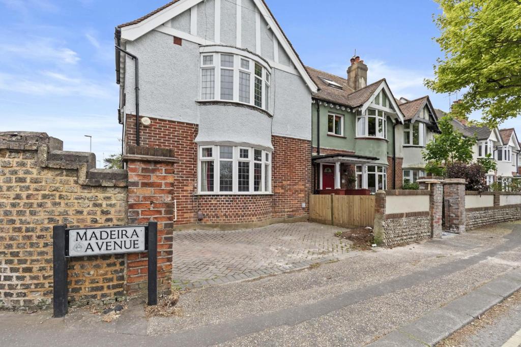 a house with a sign in front of it at Pebble Corner with Free Parking By My Getaways in Worthing