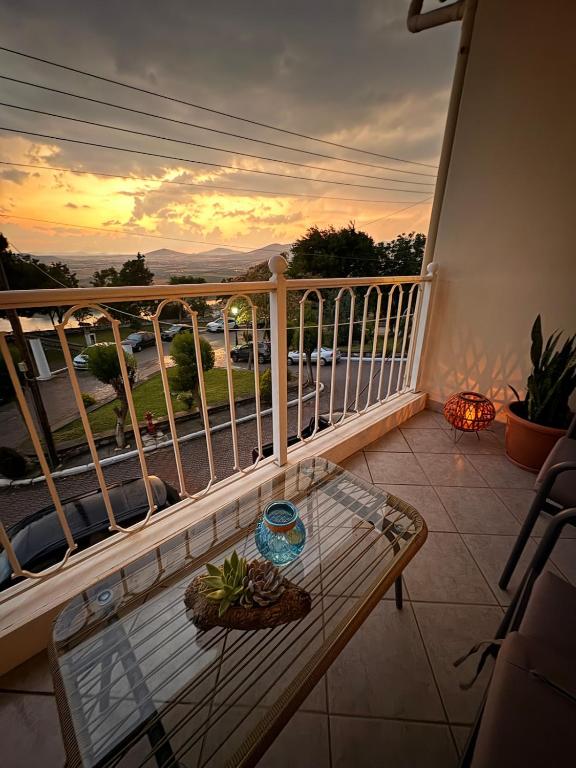 a balcony with a table and a view of a street at Neraida view in Neráïdha