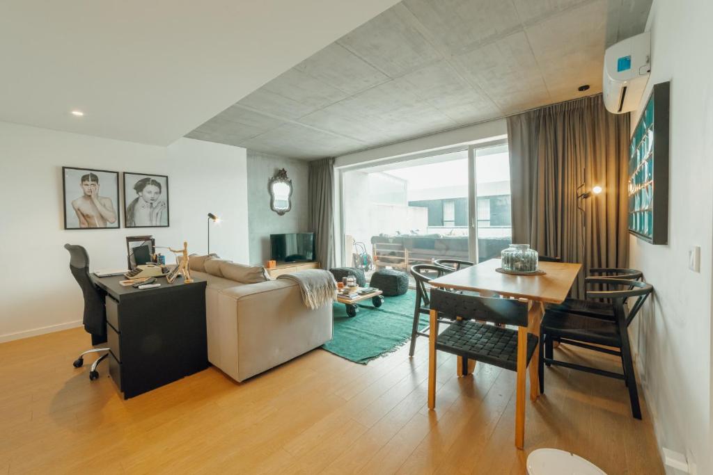 a living room with a couch and a table at Beach & Sun Apartment by Vacationy in Bomfim