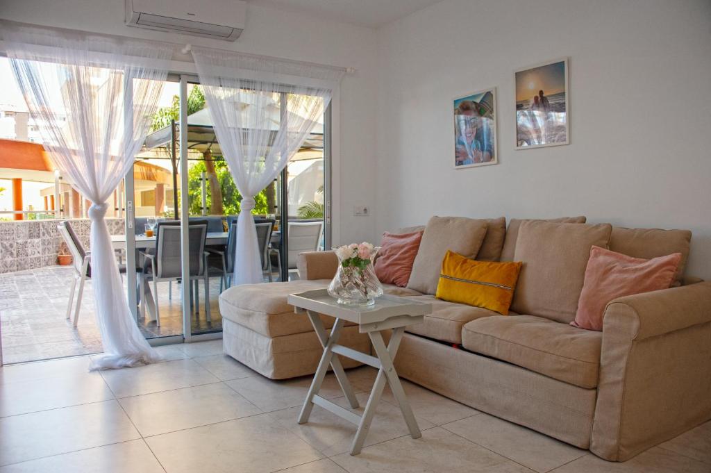 a living room with a couch and a table at Happy Space Apartment in Los Cristianos
