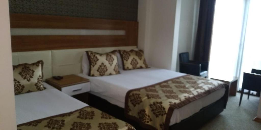 Postel nebo postele na pokoji v ubytování Afyon Grand Arı Hotel