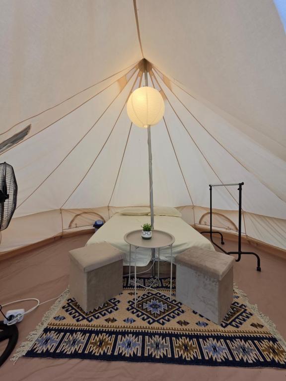 a room with a table in a tent at Glamping Costinești in Costinesti