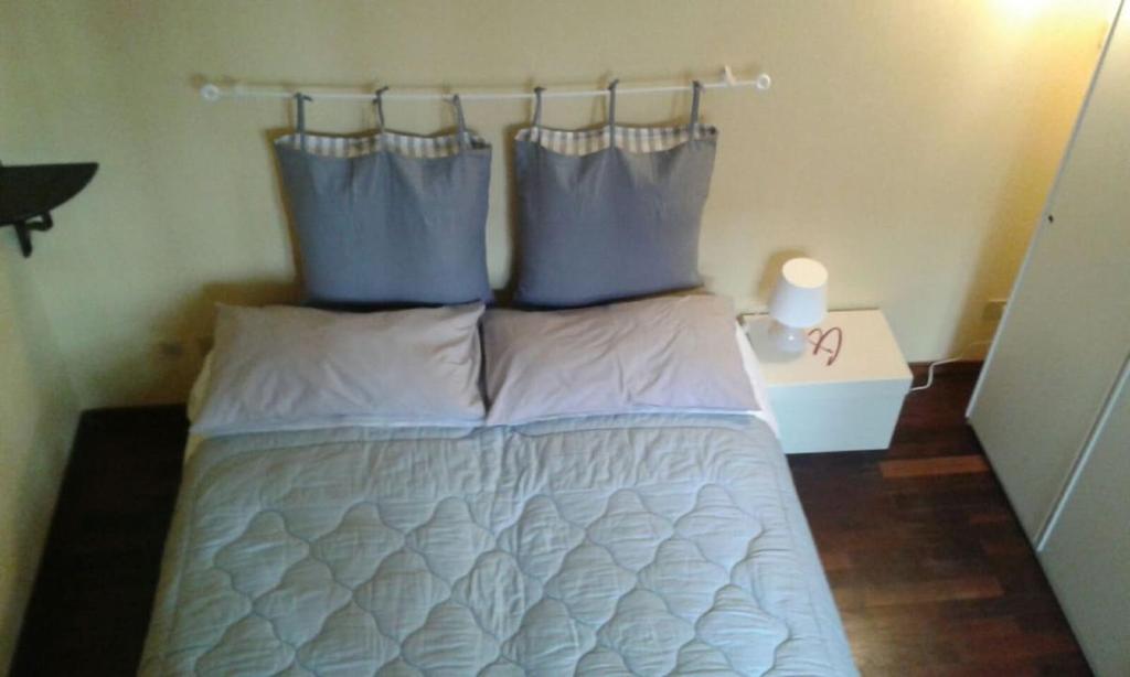 un letto con due cuscini sopra in una stanza di Oasi La Francoise a Rozzano