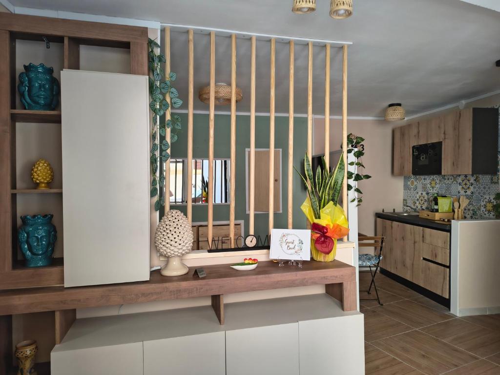a kitchen with a table in a room at Casuzza Nica e Bedda-Centro storico in Palermo