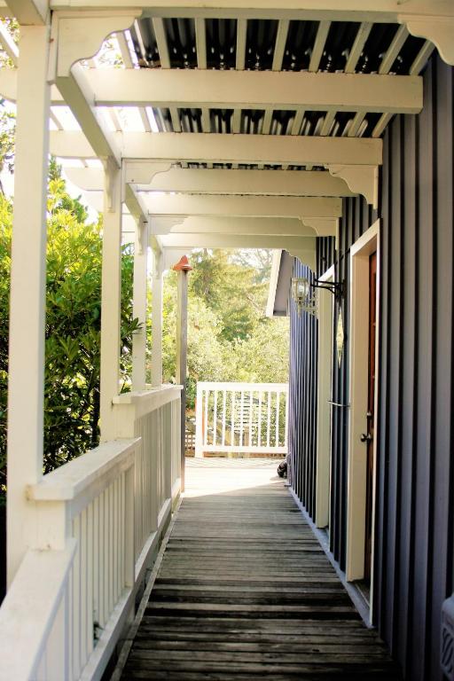 a walkway to a house with a white pergola at Elegant Carmel Cottage in Carmel