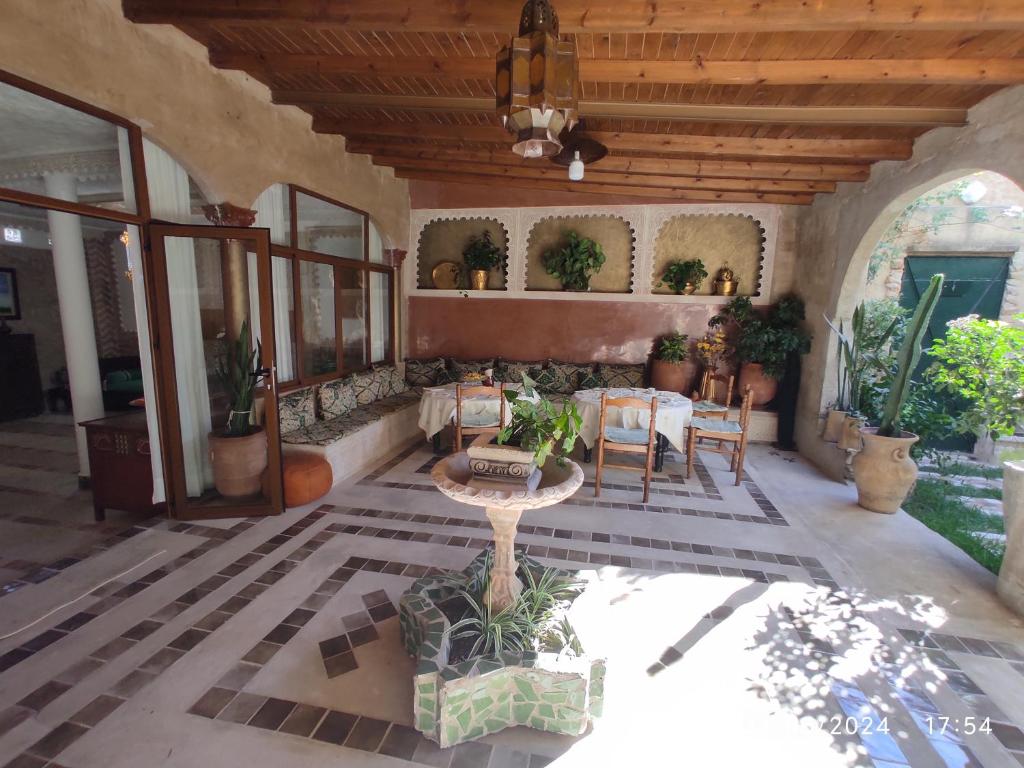 a patio with a table and chairs in a house at Maison d'hotes in Tangier