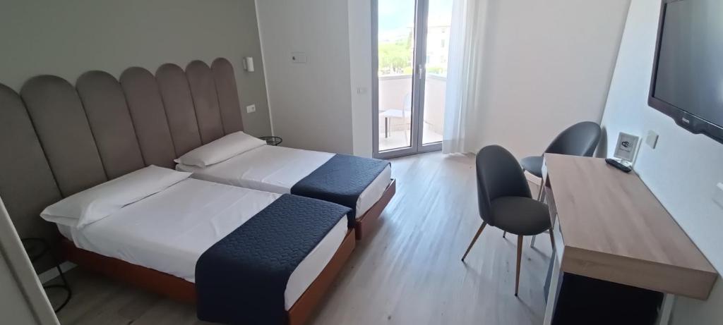Postel nebo postele na pokoji v ubytování Hotel Everest Arco