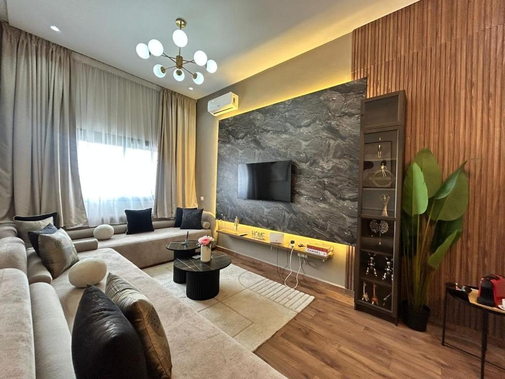 a living room with a couch and a tv at Cozy studio 5 min Casa port Parking Netflix in Casablanca