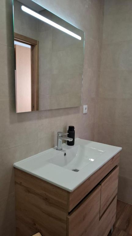 a bathroom with a sink and a mirror at Casinhas do Campo by Gerês Valley in Campo do Gerês