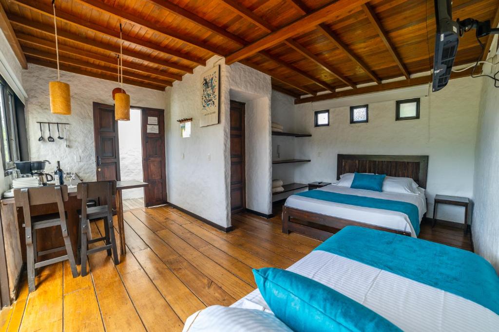 Llit o llits en una habitació de Salento Pequeño Hotel