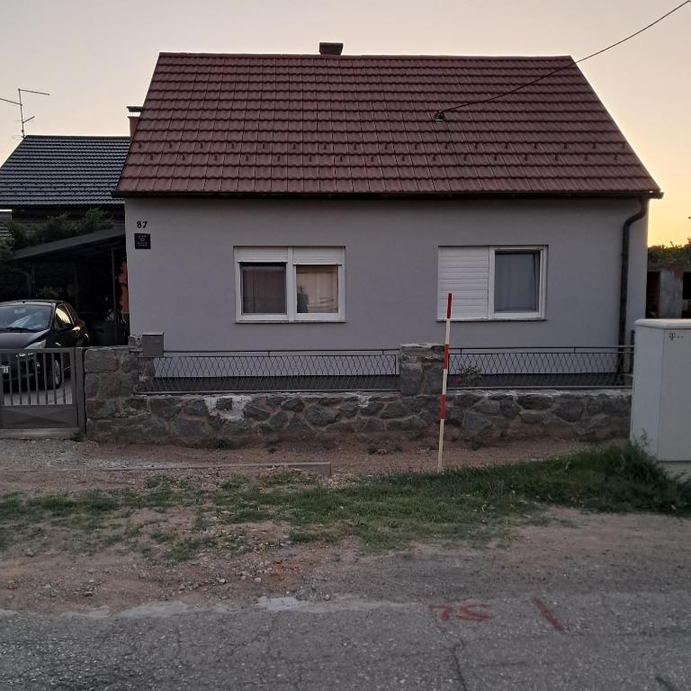 a white house with a brown roof at kuća za odmor Dolno in Sisak