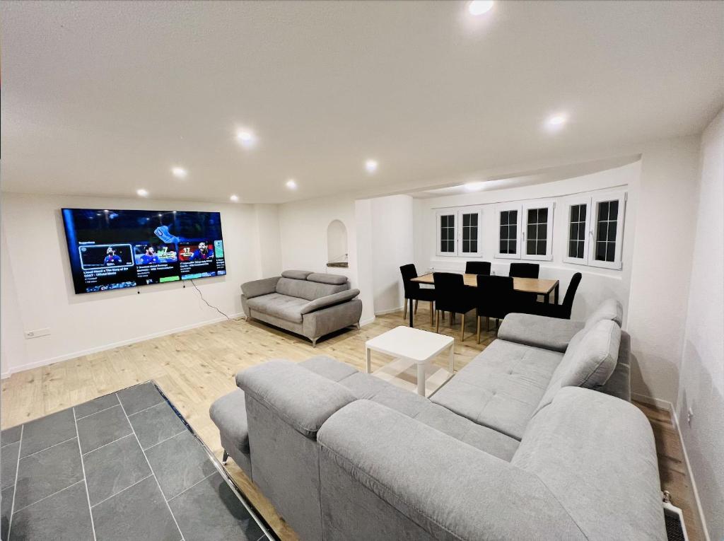 a living room with a couch and a dining room at Gemütliches Wohnung für Familien und Gruppen in Küblis