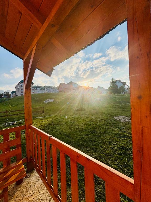 a window on a porch with a view of a field at Alfa Omega Žabljak in Žabljak