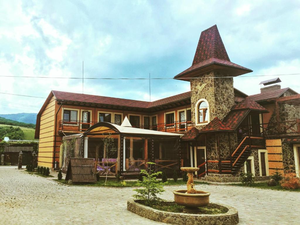 a large house with a tower on top of it at Minihotel Zolotoe Runo in Ploskoye