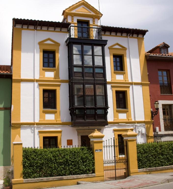 a yellow and white house with a balcony at AT Villa Manola in Colombres