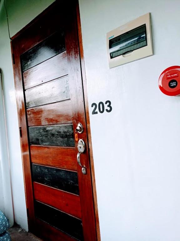 a wooden door with the number twentythree next to it at 203 Casa de Rany in Daro