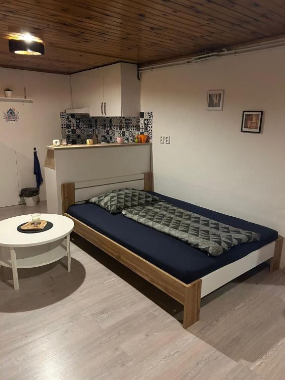a bed and a table in a room at U krbu in Jindřichovice