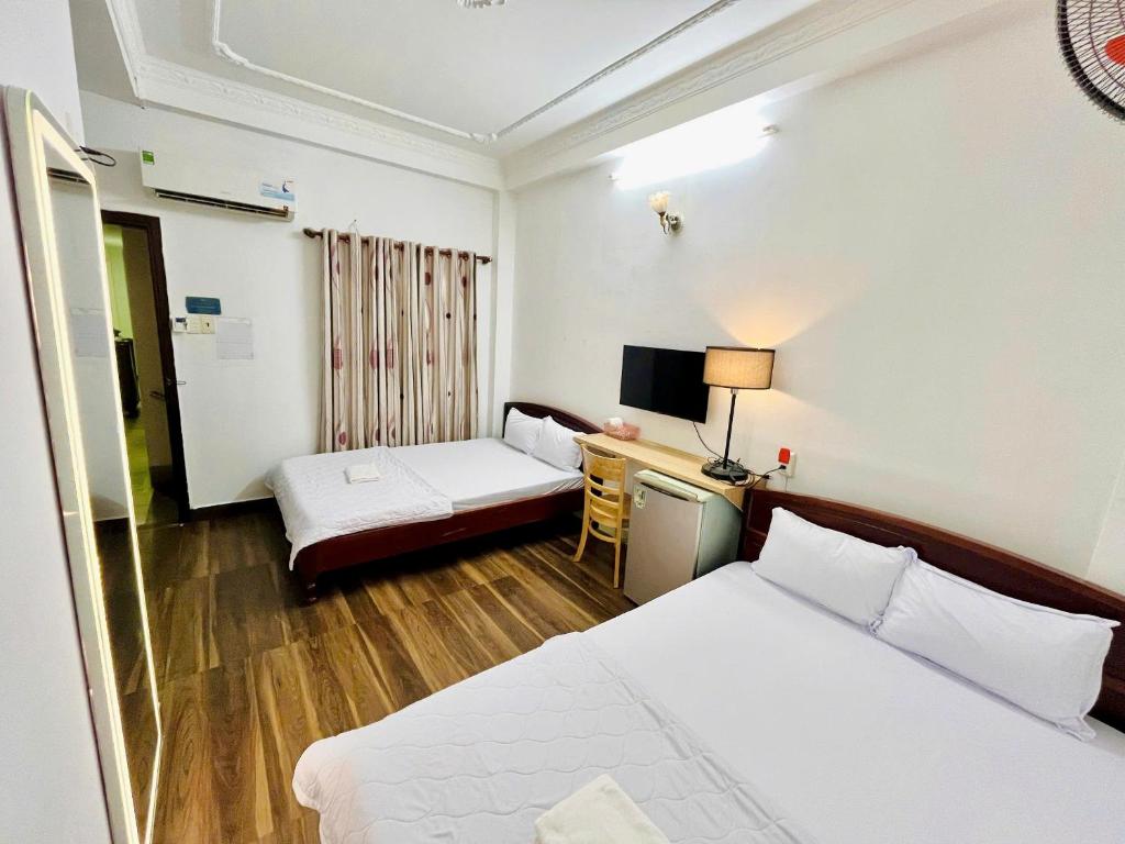 Postel nebo postele na pokoji v ubytování Thanh Huyền Hotel Vũng Tàu