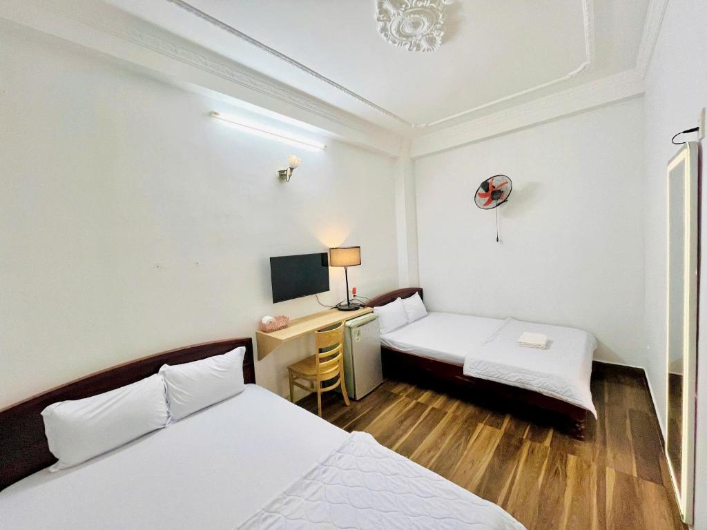 Postel nebo postele na pokoji v ubytování Thanh Huyền Hotel Vũng Tàu