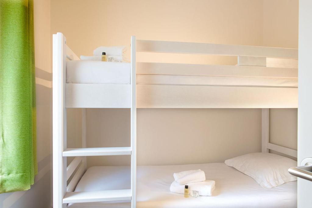a white bunk bed in a small room at Hôtel Vacances Bleues Delcloy in Saint-Jean-Cap-Ferrat
