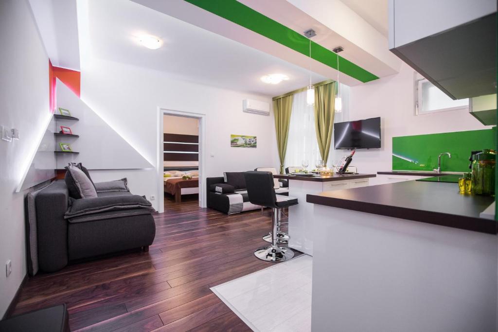 a living room with a couch and a desk at VisitZagreb Emerald in Zagreb