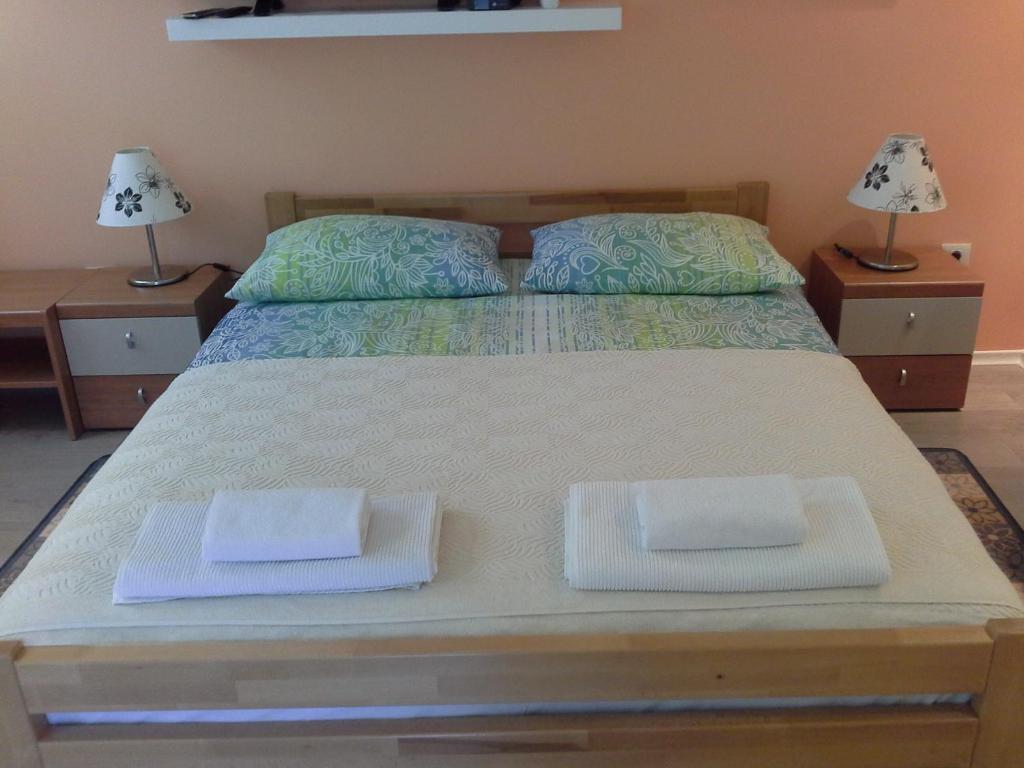 a bedroom with a bed with two towels on it at Apartment Zadraga in Tolmin