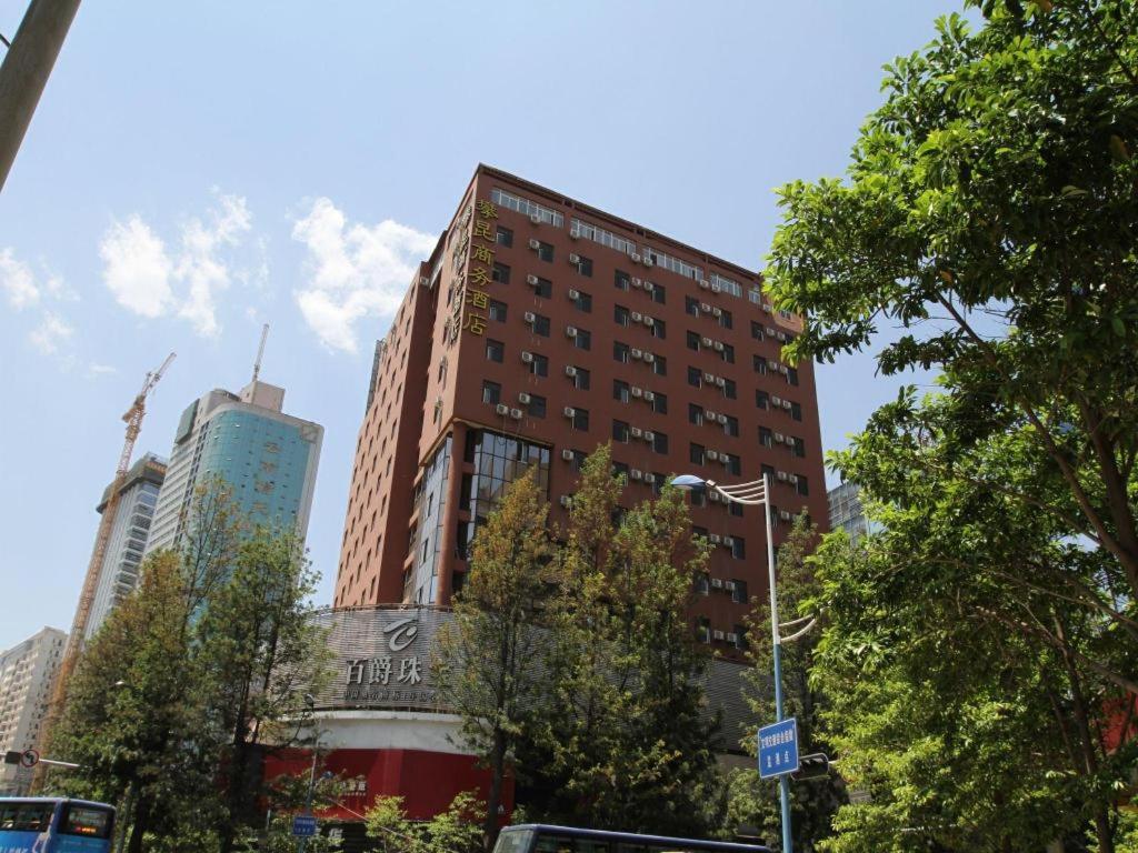 ein hohes Gebäude mitten in einer Stadt in der Unterkunft Pankun Business Hotel in Kunming