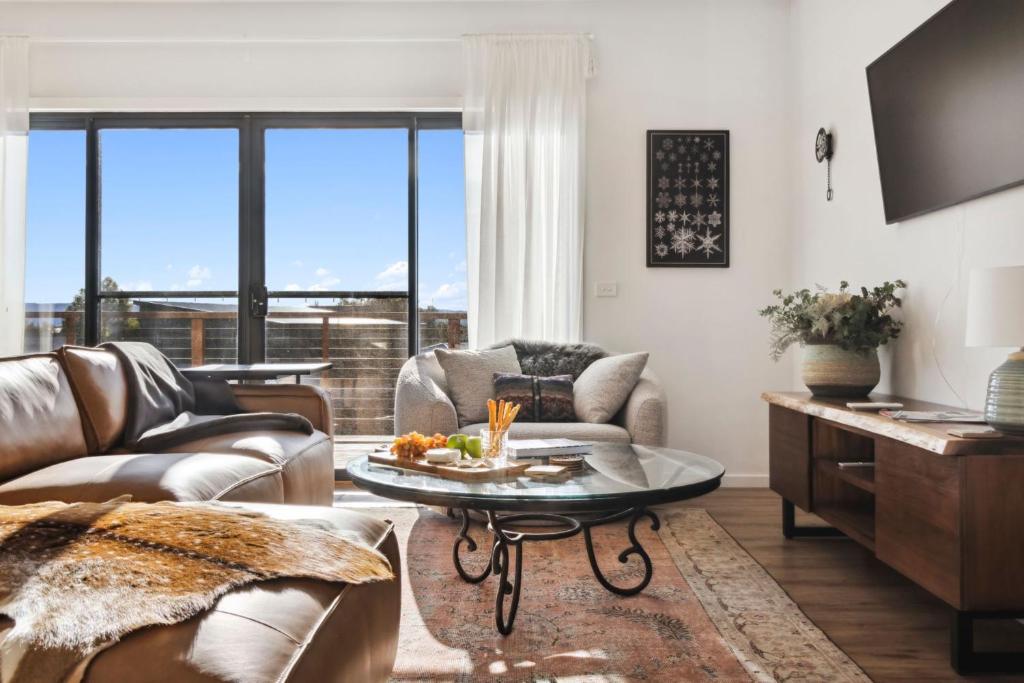 a living room with a couch and a table at The Crystal Palace 2 in Jindabyne