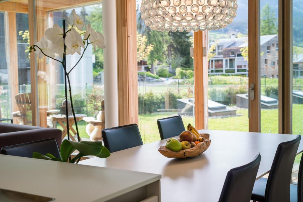 a dining room table with a bowl of fruit on it at Edelweiss Mountain Suites 04-01 in Flims