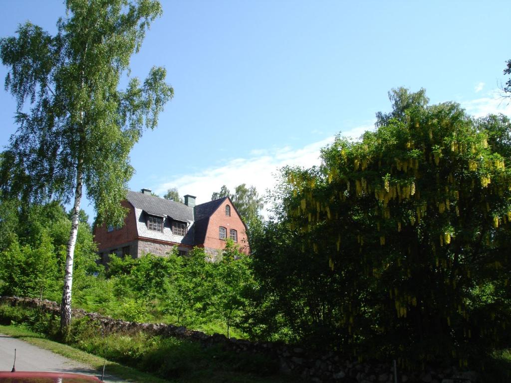 an old house with trees in front of it at Marston Hill in Mullsjö