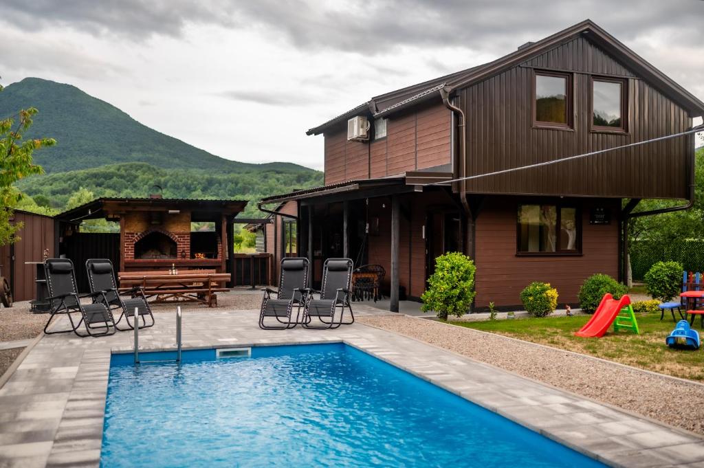 a house with a swimming pool in front of a house at Kuća za odmor Dani in Bihać