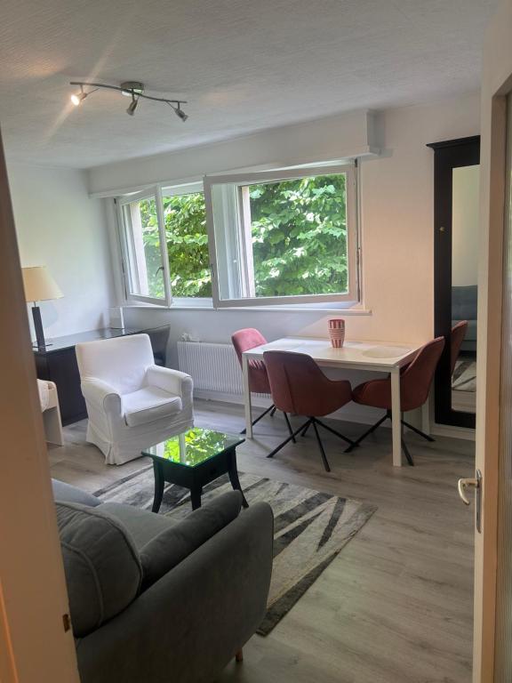 a living room with a couch and a table and chairs at cosy studio in Montreux