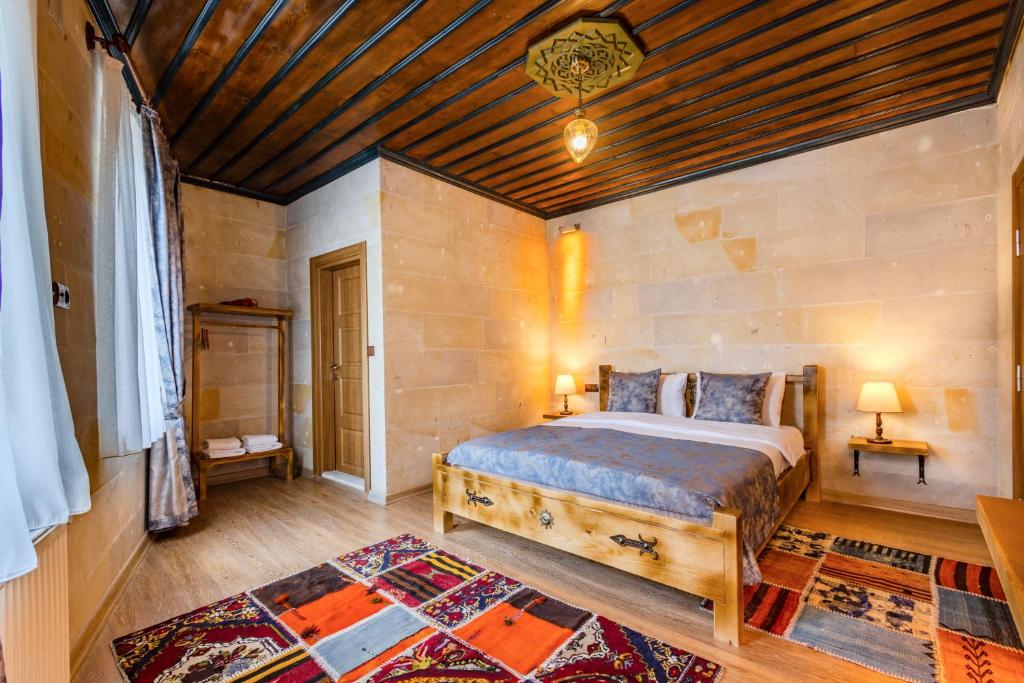 a bedroom with a bed and a wooden ceiling at Leo's Cappadocia in Goreme