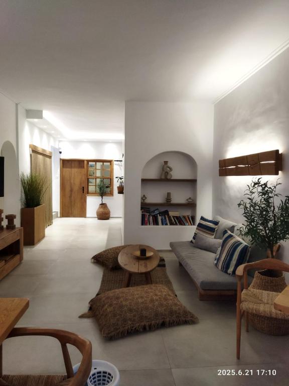 a living room with a couch and a table at Hotel Flisvos in Megalochori