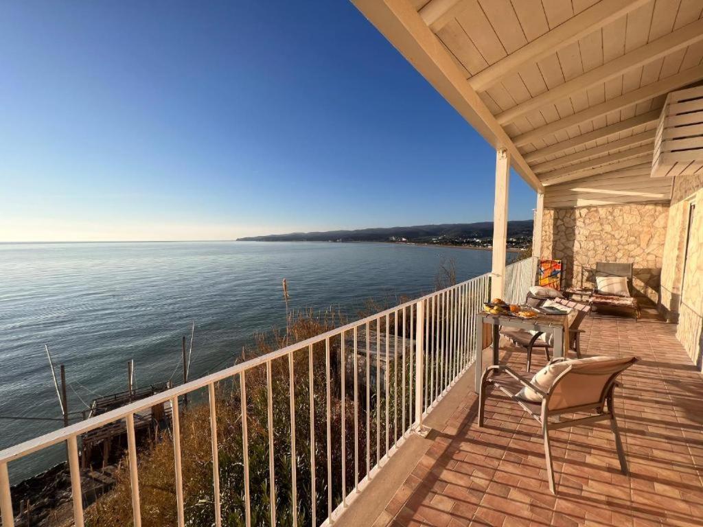 a balcony with a table and chairs and the ocean at Dolce Vita Terrace On the Ocean - Veranda Sul Mare in Vieste