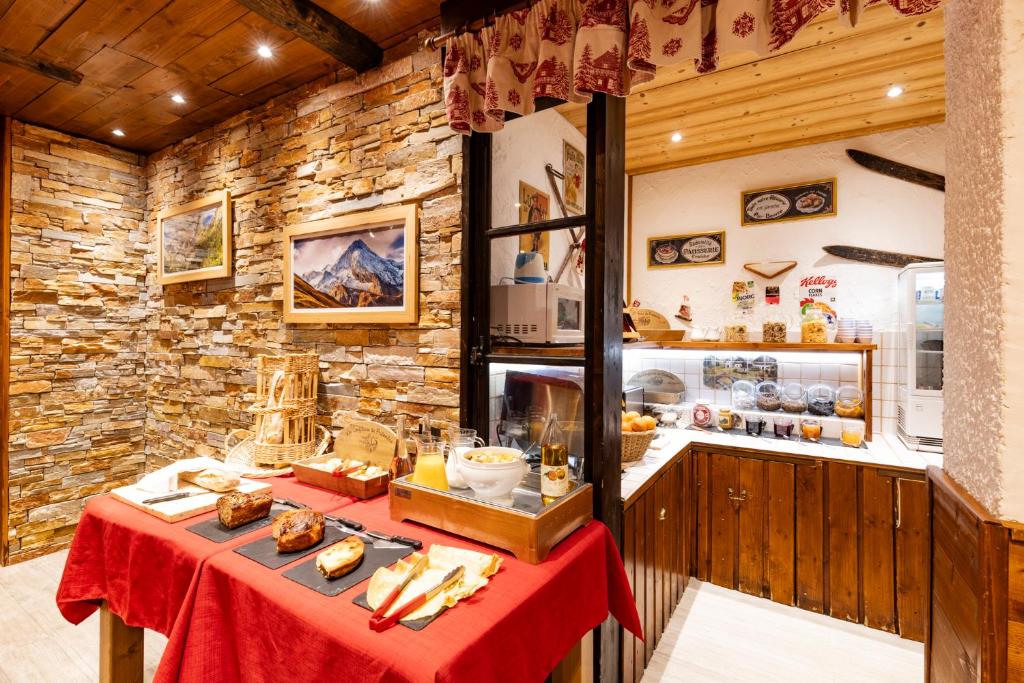 a kitchen with a table with food on it at Les Glières - Champagny-en-Vanoise in Champagny-en-Vanoise