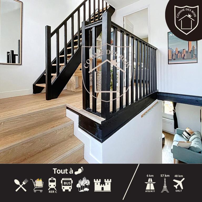 a staircase in a living room with a black and white stair case at La Tourelle des Rois in Dourdan