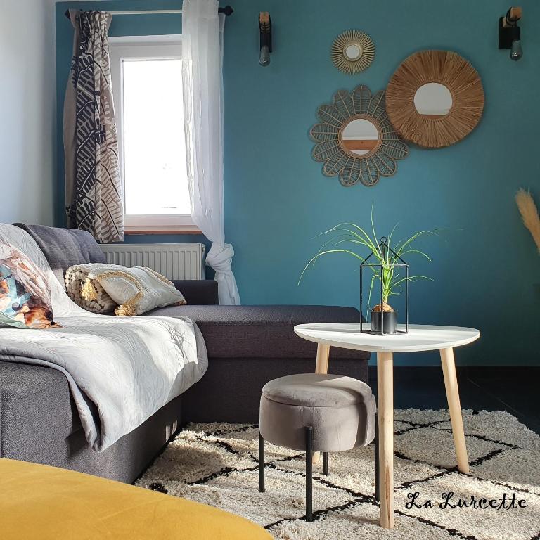 a living room with a couch and a table at Holiday home le Lurçon et la Lurcette in Libin