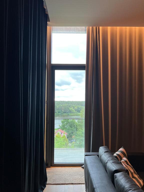 Letto o letti in una camera di Design apartment with view to Nemunas, Prienai