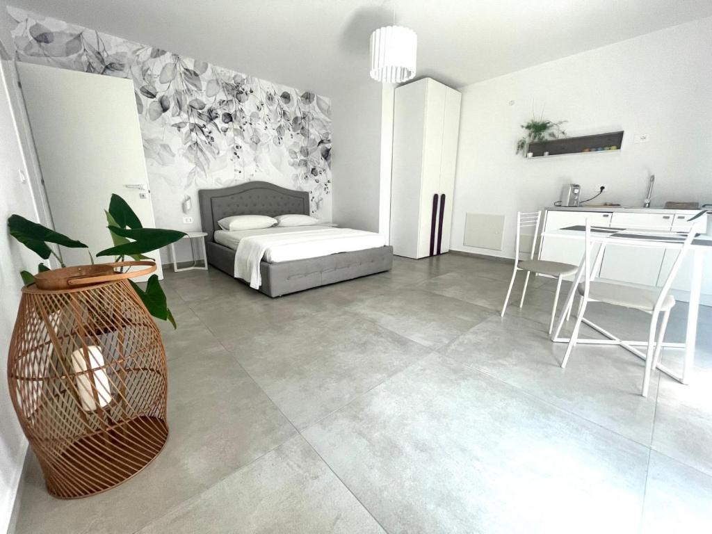 a living room with a bed and a dining room at Villa Nina in Lagosanto