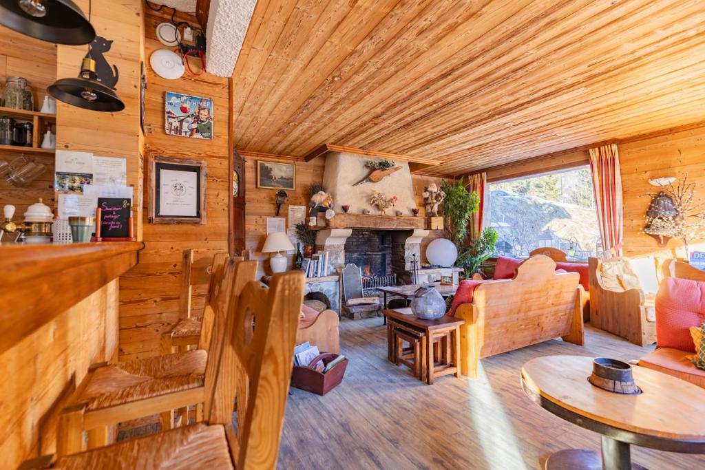 a living room filled with furniture and a fireplace at Les Glières - Champagny-en-Vanoise in Champagny-en-Vanoise