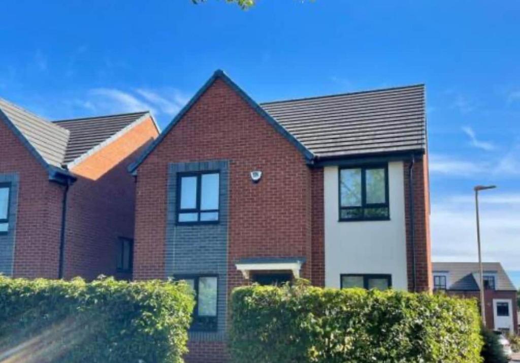 a red brick house with a black roof at Durham city free onsite parking in Sheepscar