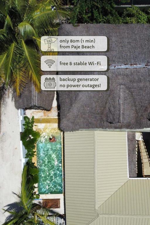 a view of a building with a pool and street signs at Mlango Paje Villa Boutique in Paje