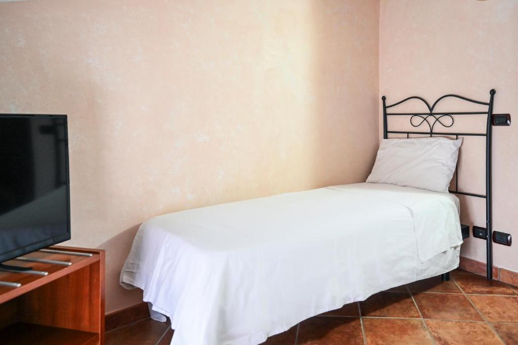 Postel nebo postele na pokoji v ubytování Hotel Palazzo Krataiis