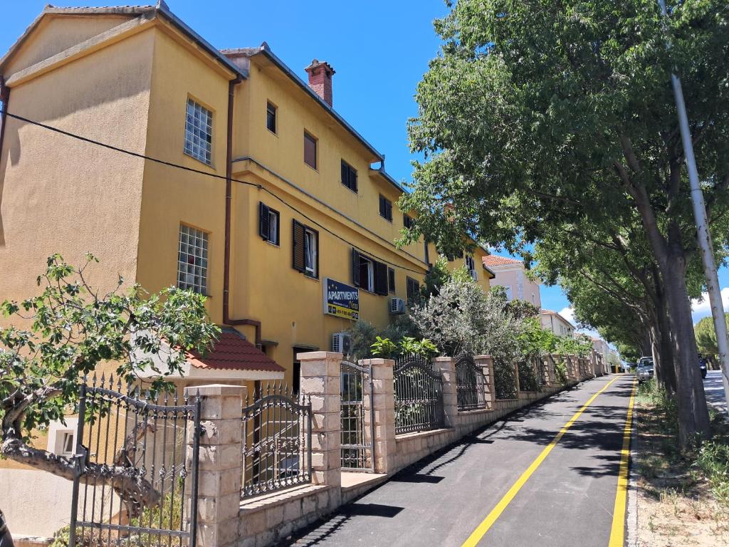 a yellow house on the side of a street at Azizam hostel in Split