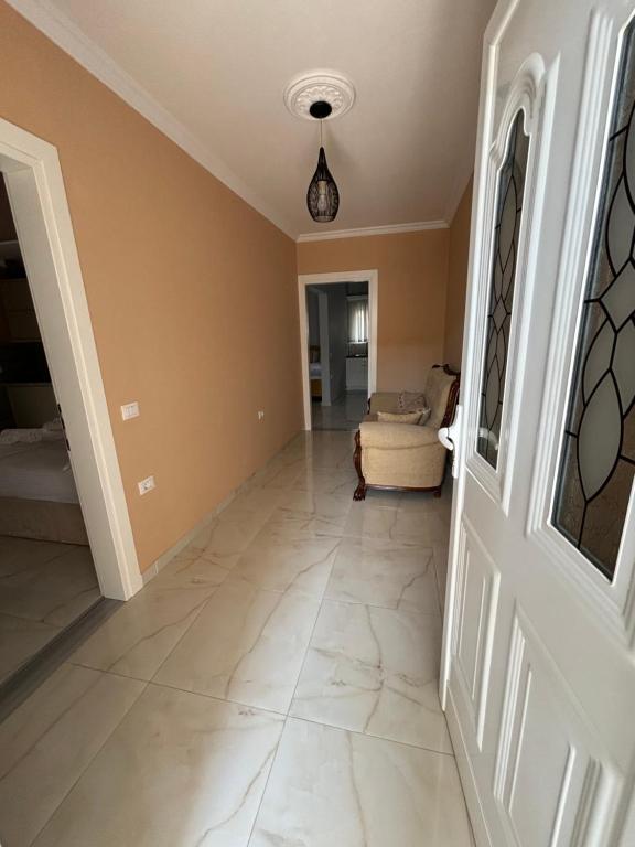 a hallway of a home with a large tile floor at Blissful Apartments in Sarandë