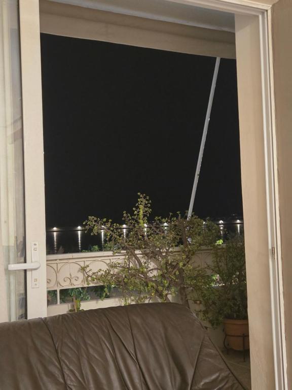 a window with a view of a dark sky at Kons beach front in Kalamata