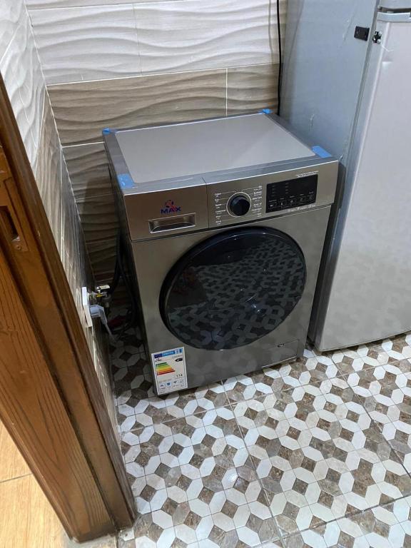 a microwave sitting on the floor next to a refrigerator at 2bedroom apartment with balcony in Aqaba