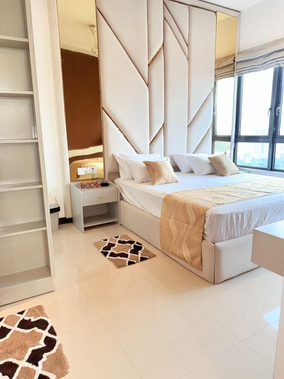 a bedroom with a bed and a large window at Chevalra Luxury TRI-ZEN Apartment in Central Colombo - Galle-Face & Lotus Tower View in Colombo
