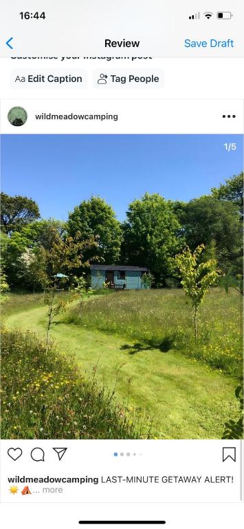 a screenshot of a picture of a house in a field at Wild Meadow Camping in Llandysul